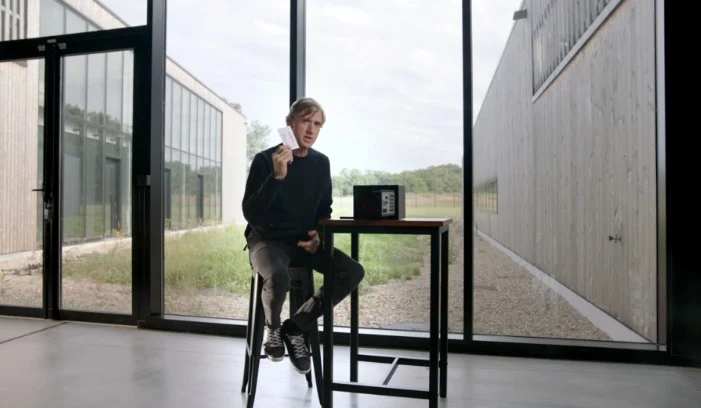 Ian Rogers holding a recovery phrase paper.