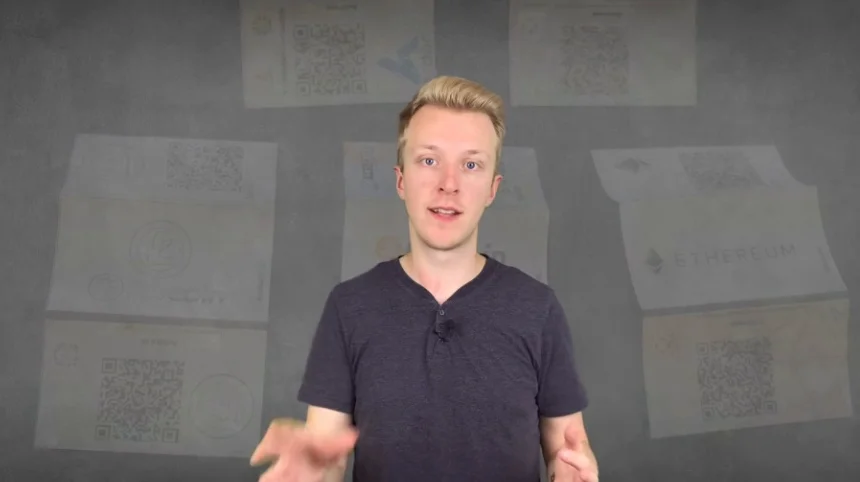 Several printed paper cards, each with a QR code and cryptocurrency logo like Bitcoin, Ethereum, and Litecoin.