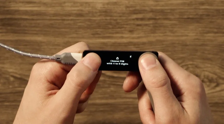 The small Ledger Nano X screen prompting to 'Choose PIN with 4 to 8 digits'.