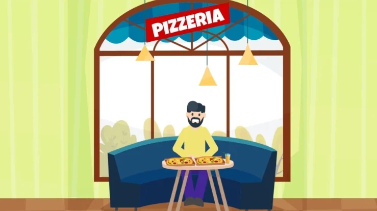 A man sitting at a table with two large pizzas.