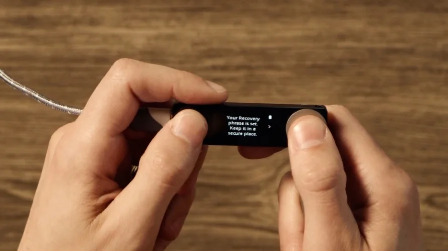 The Ledger Nano X screen displaying 'Your Recovery phrase is set. Keep it in a secure place.'